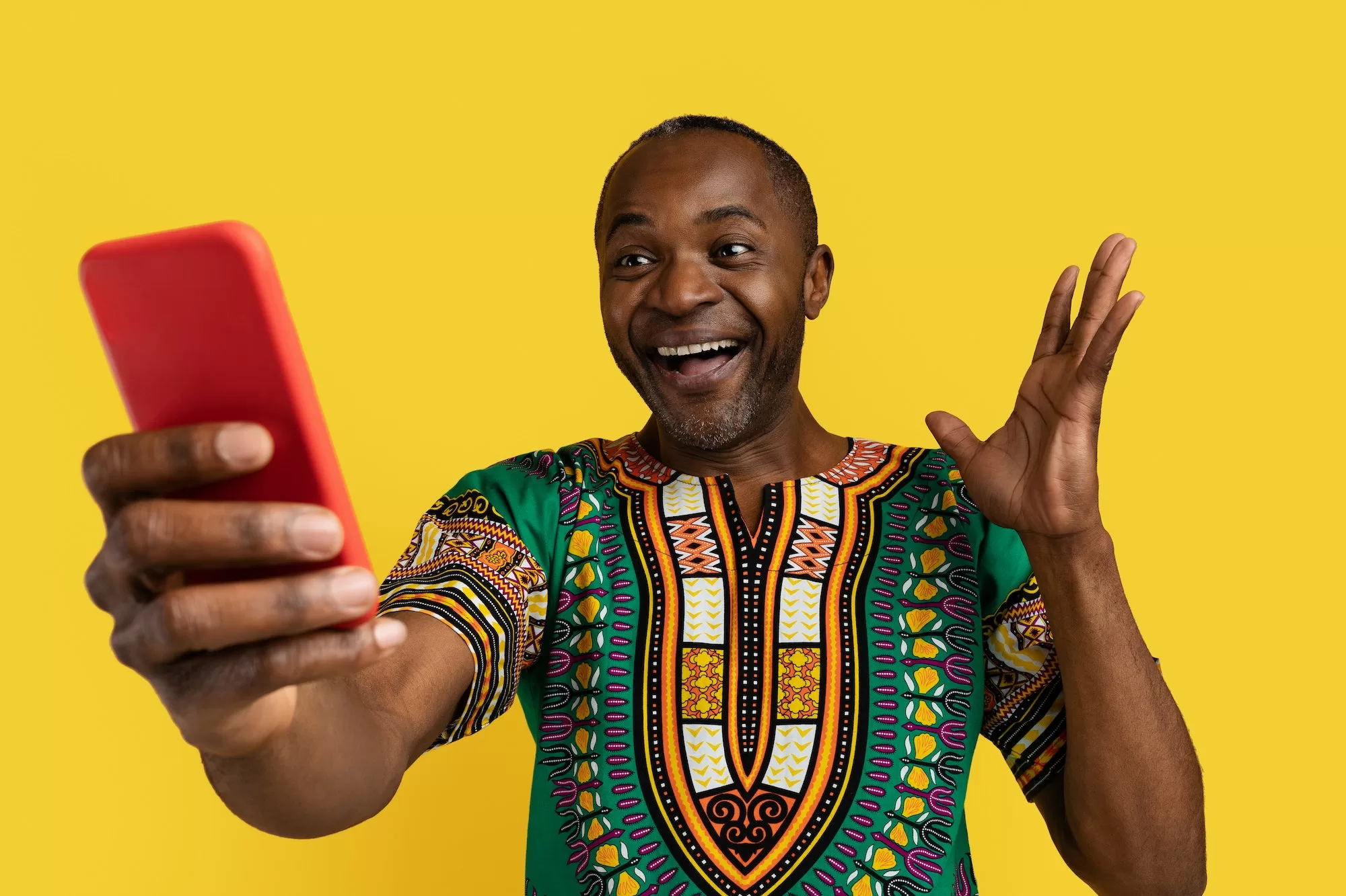 Excited black man in African shirt looking at a winning Supreme Betting Bet Slip