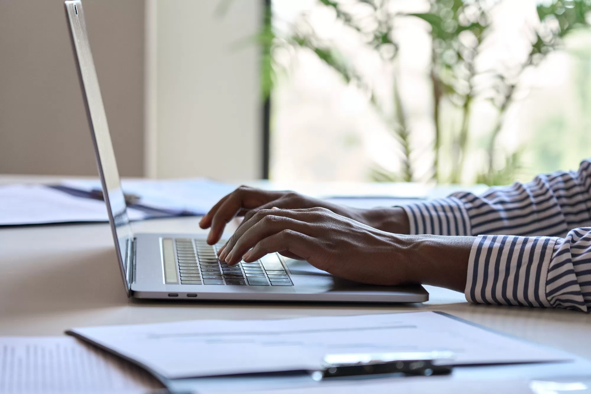 Young African black female hands typing on laptop computer keyboard. How to Make Money in Namibia through Transcription