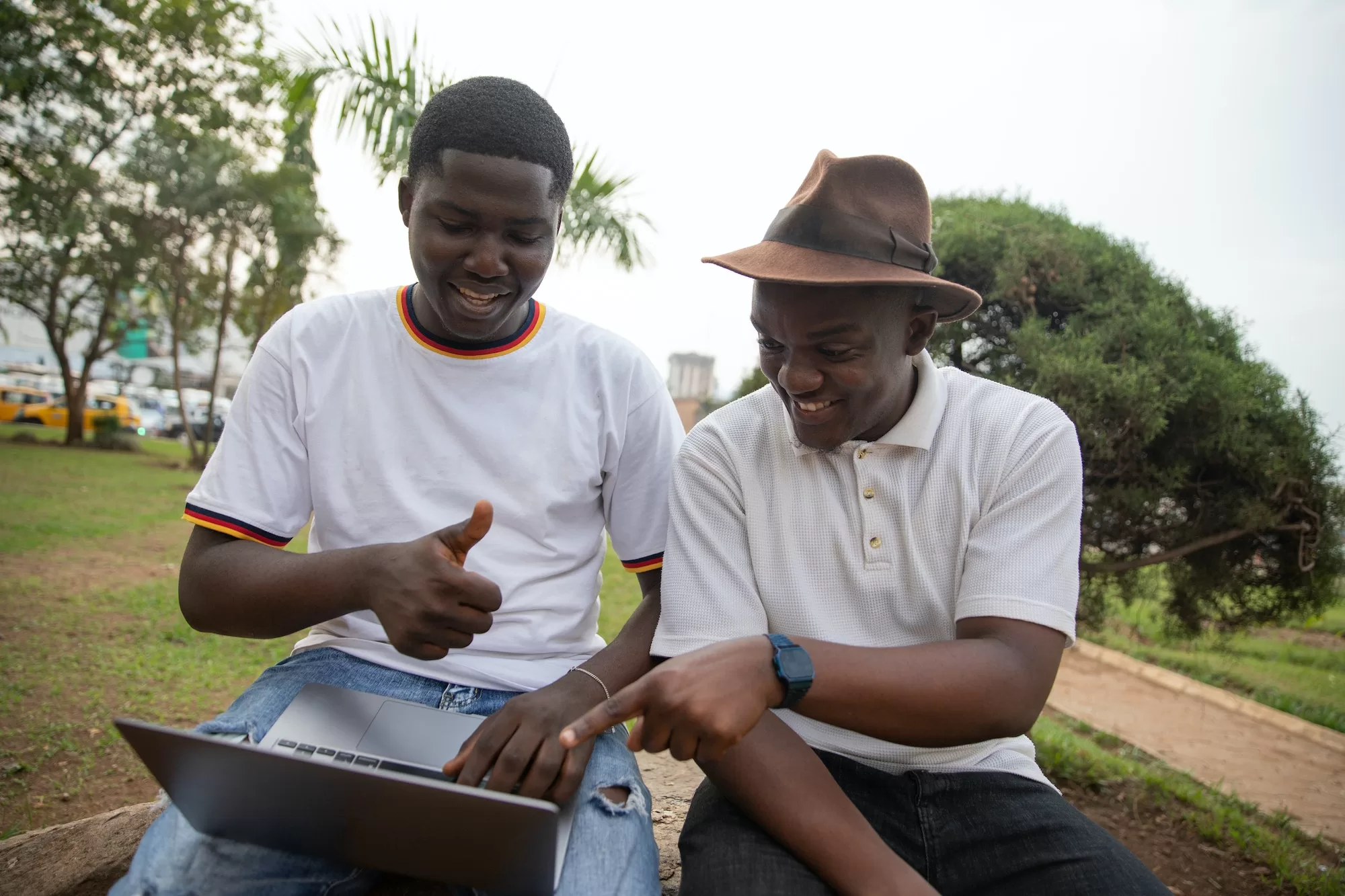 Two students study together using laptop in Africa at a public park | Standard Bank Bursary Programme