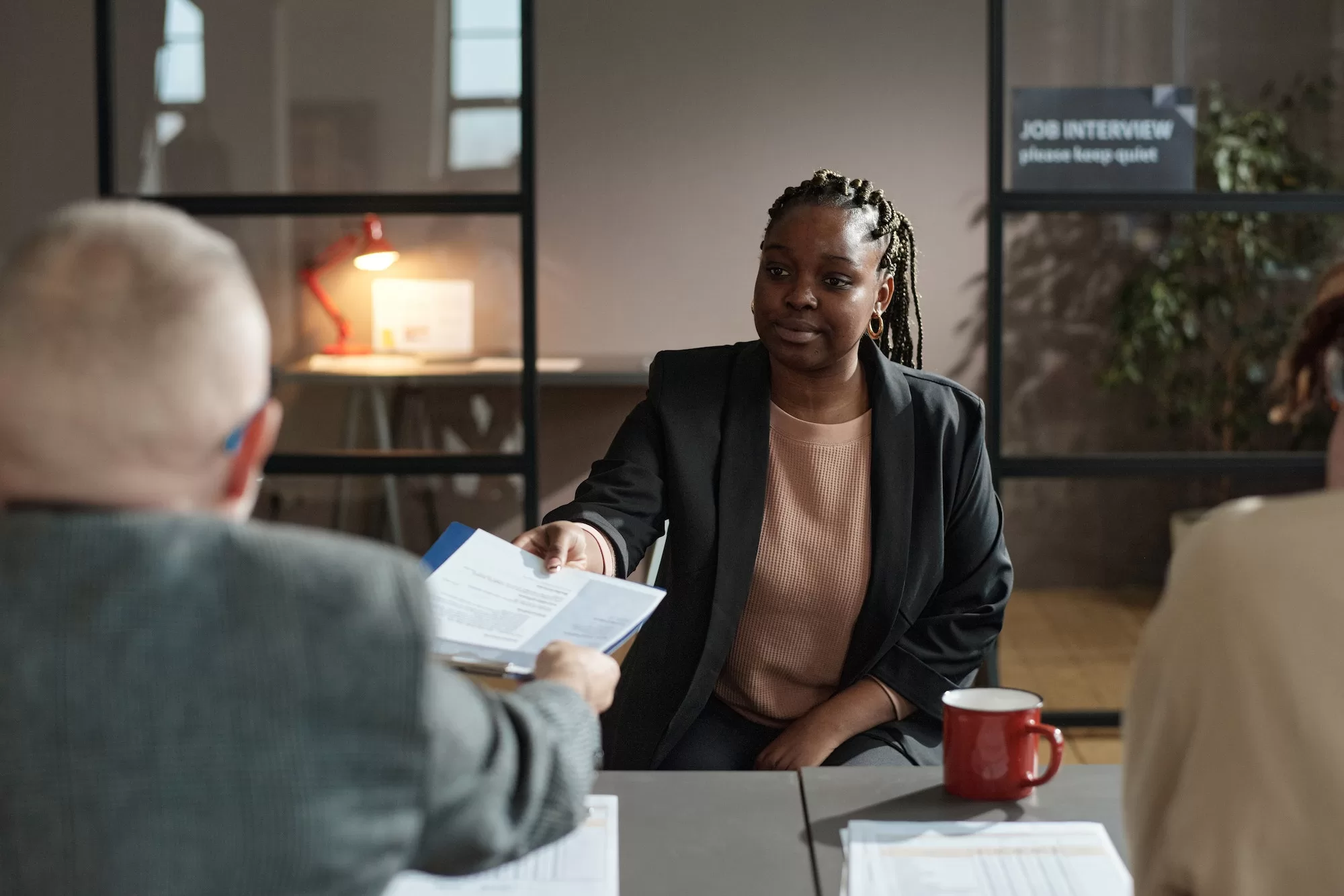 Woman presenting her resume at job interview | How to Master Job Hunting in South Africa: Insider Tips and Apps