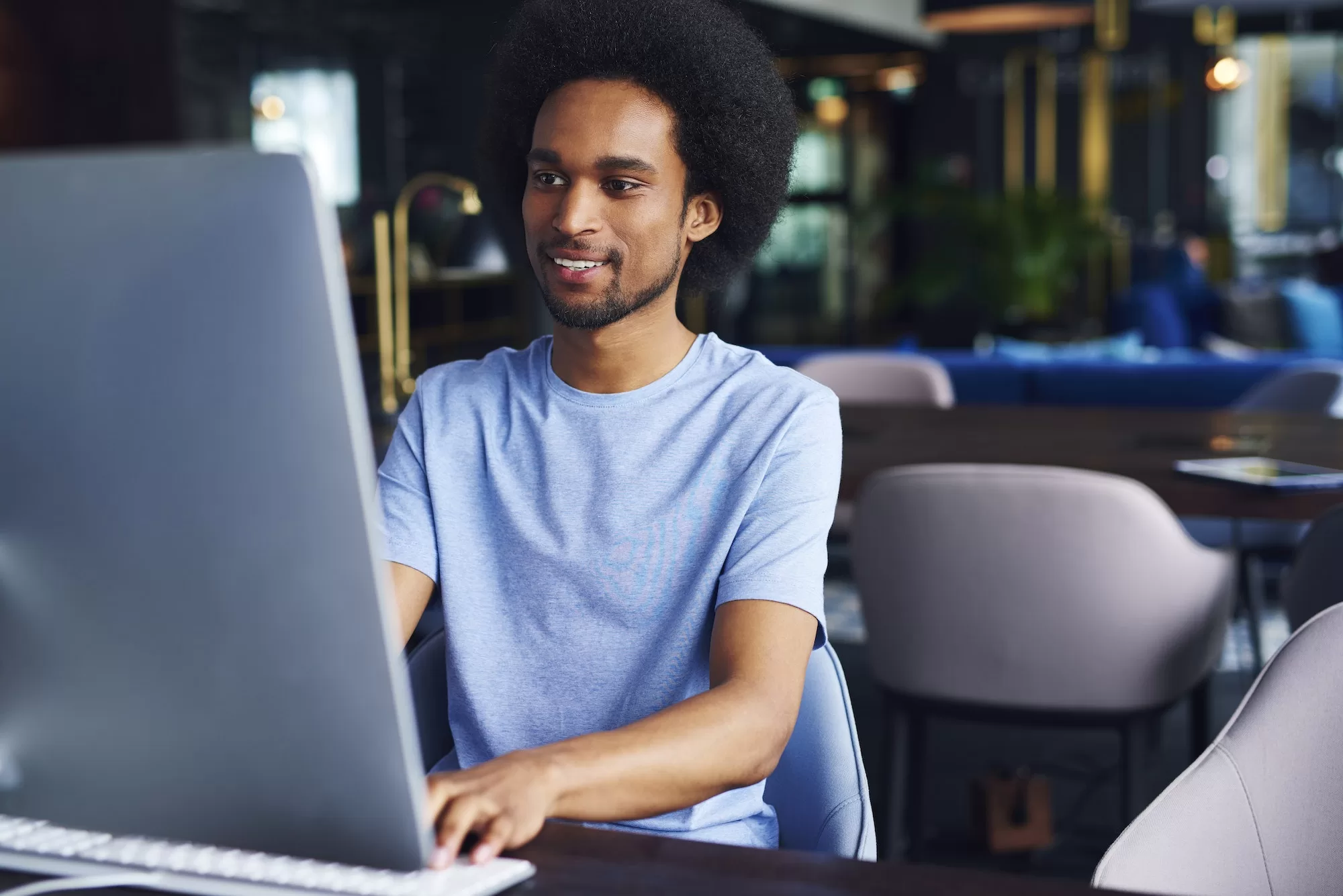 ITAS Online Registration - African man working on computer in the office