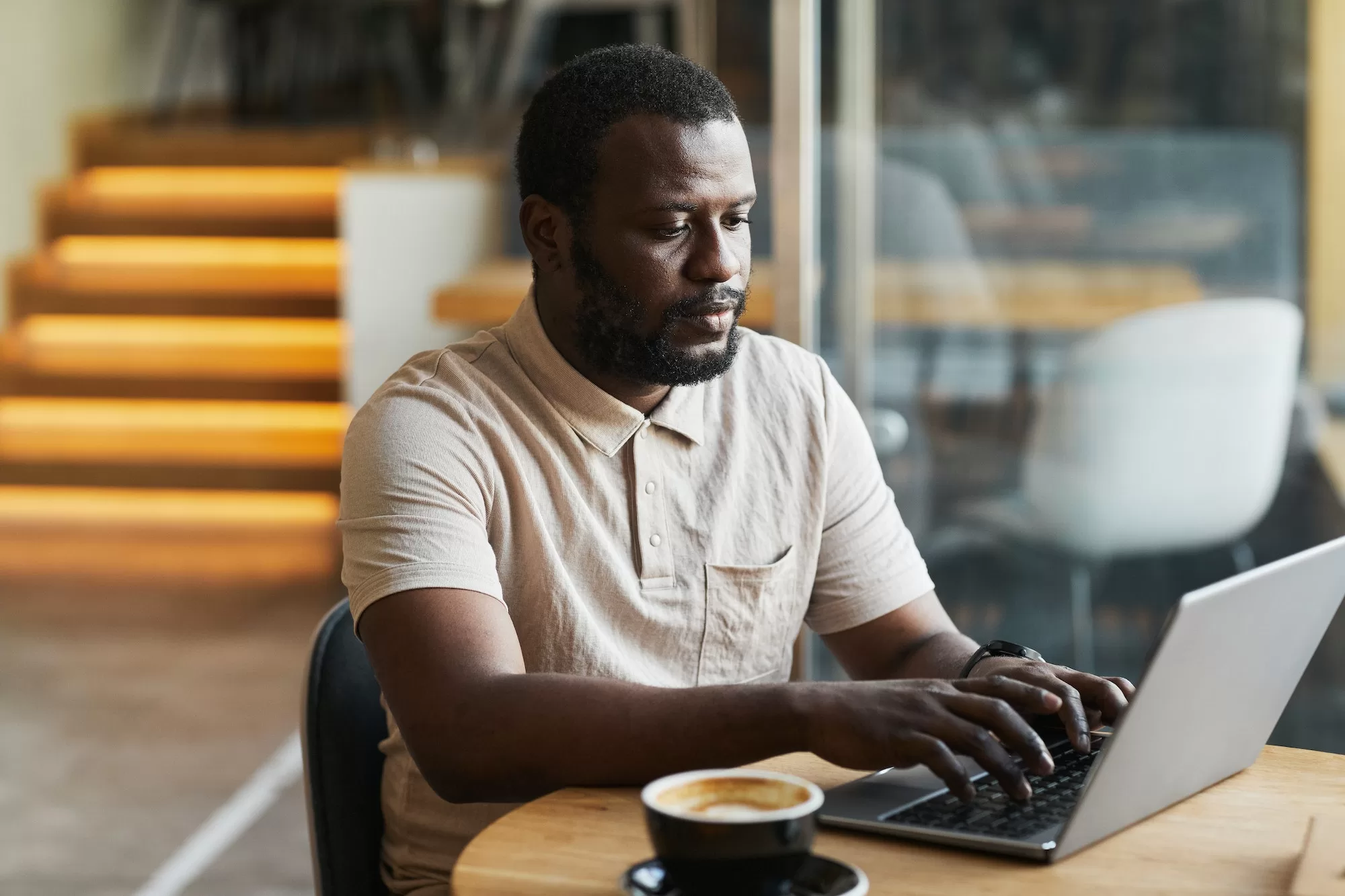 Demystifying Employee Tax ETX Return Filing: A Comprehensive Guide - Black Man Using Laptop in Cafe
