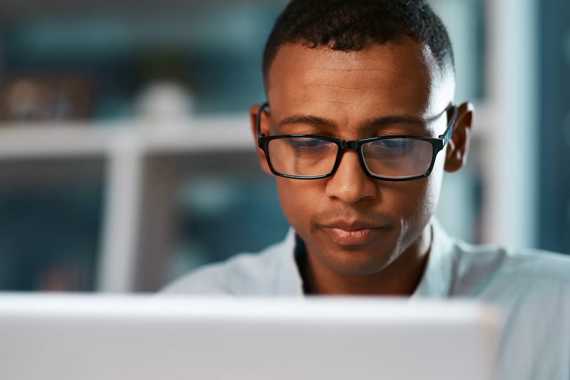 Submit Your Individual Tax Return on ITAS - Shot of a handsome young businessman working on his laptop during a late night shift at work