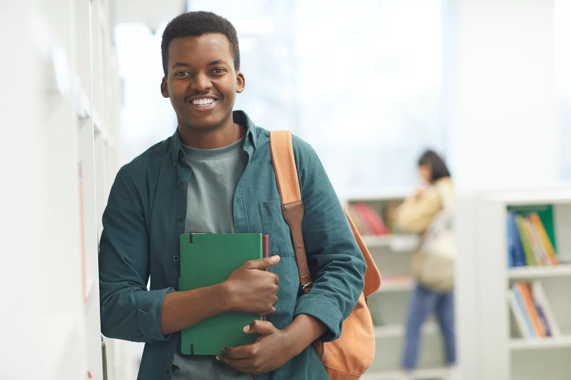 Seamless UNAM online application for Returning Students: Smiling African Student Posing in Library