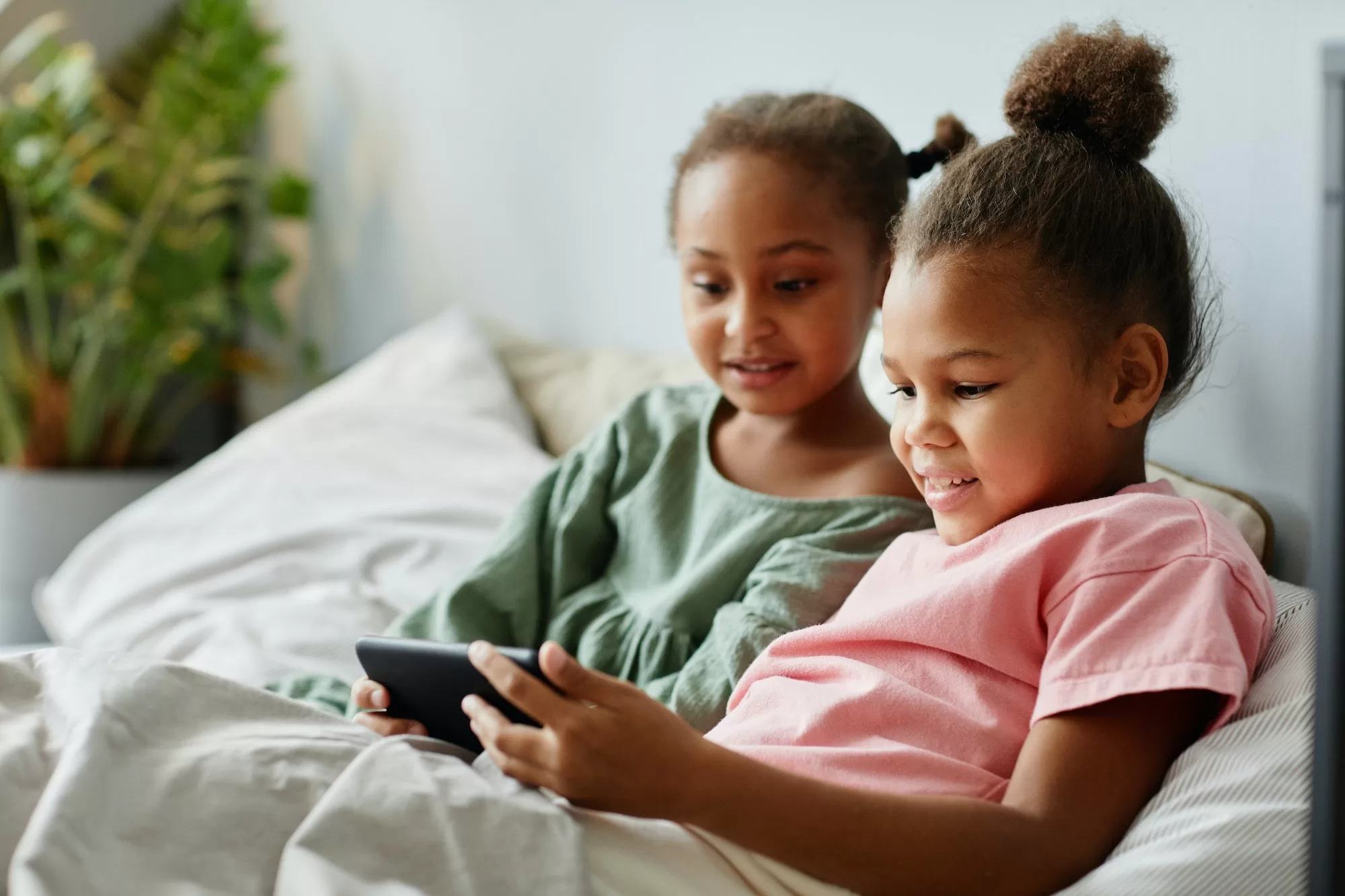 Embrace the Weekend with Weekend Jiva. Two Sisters Using Smartphone Together