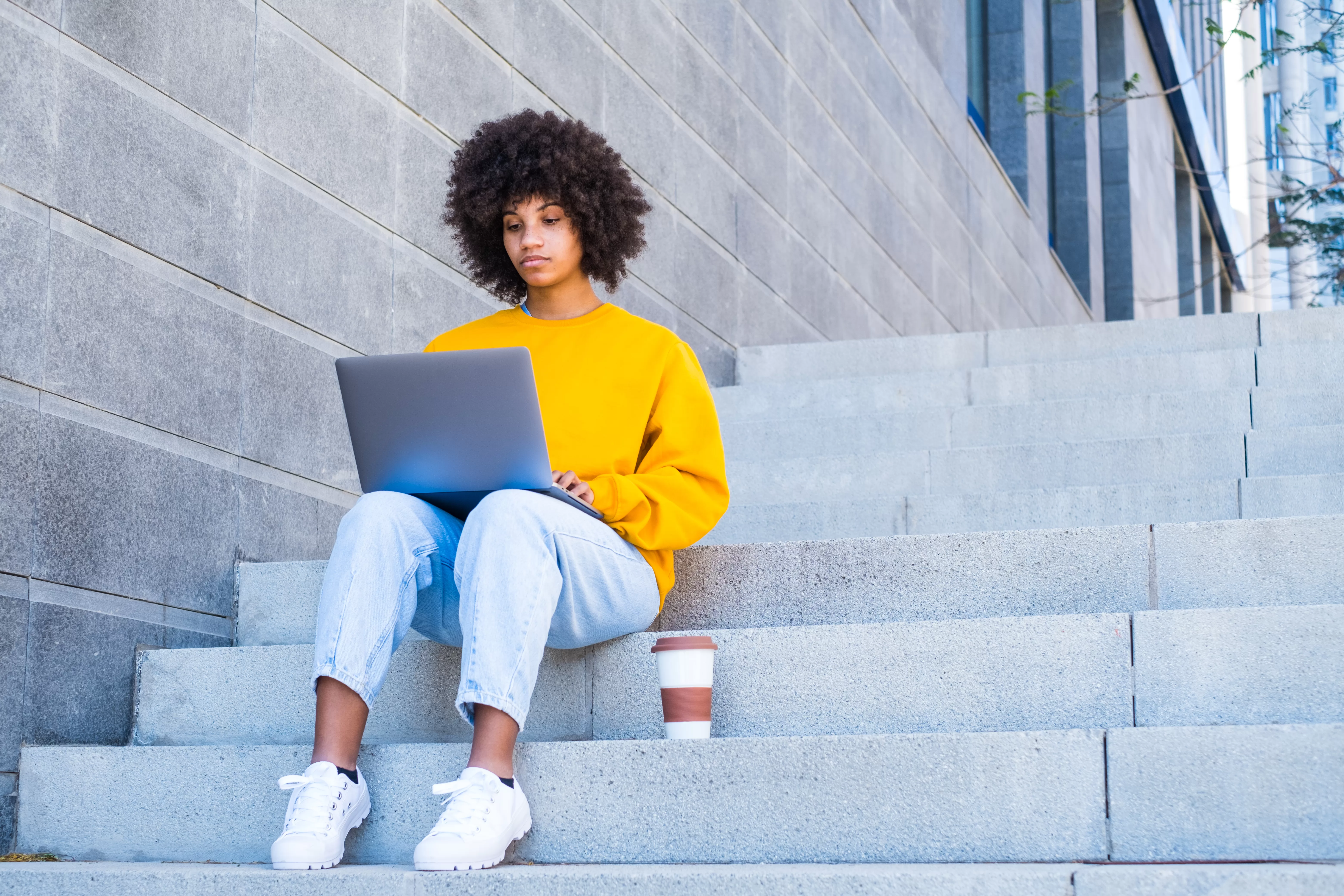 Happy young african businesswoman worker student relaxing sit on the stairs of the city. aveling the Spectrum: Nampost Business School's Focused Arsenal