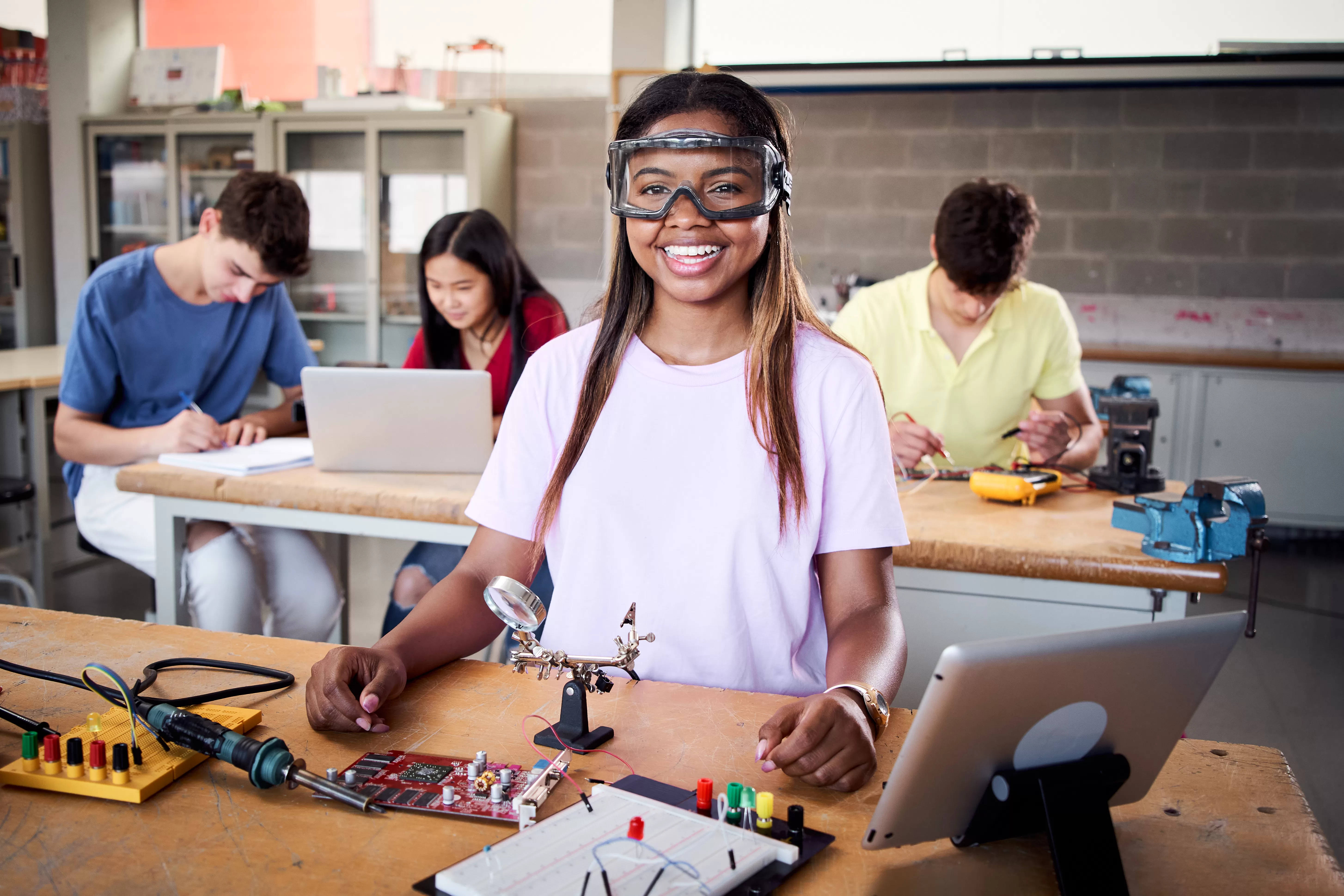 Looking at camera portrait of young student wearing safety goggles in technical vocational training. NamVoc Vocational Institute's National Vocational Certificates