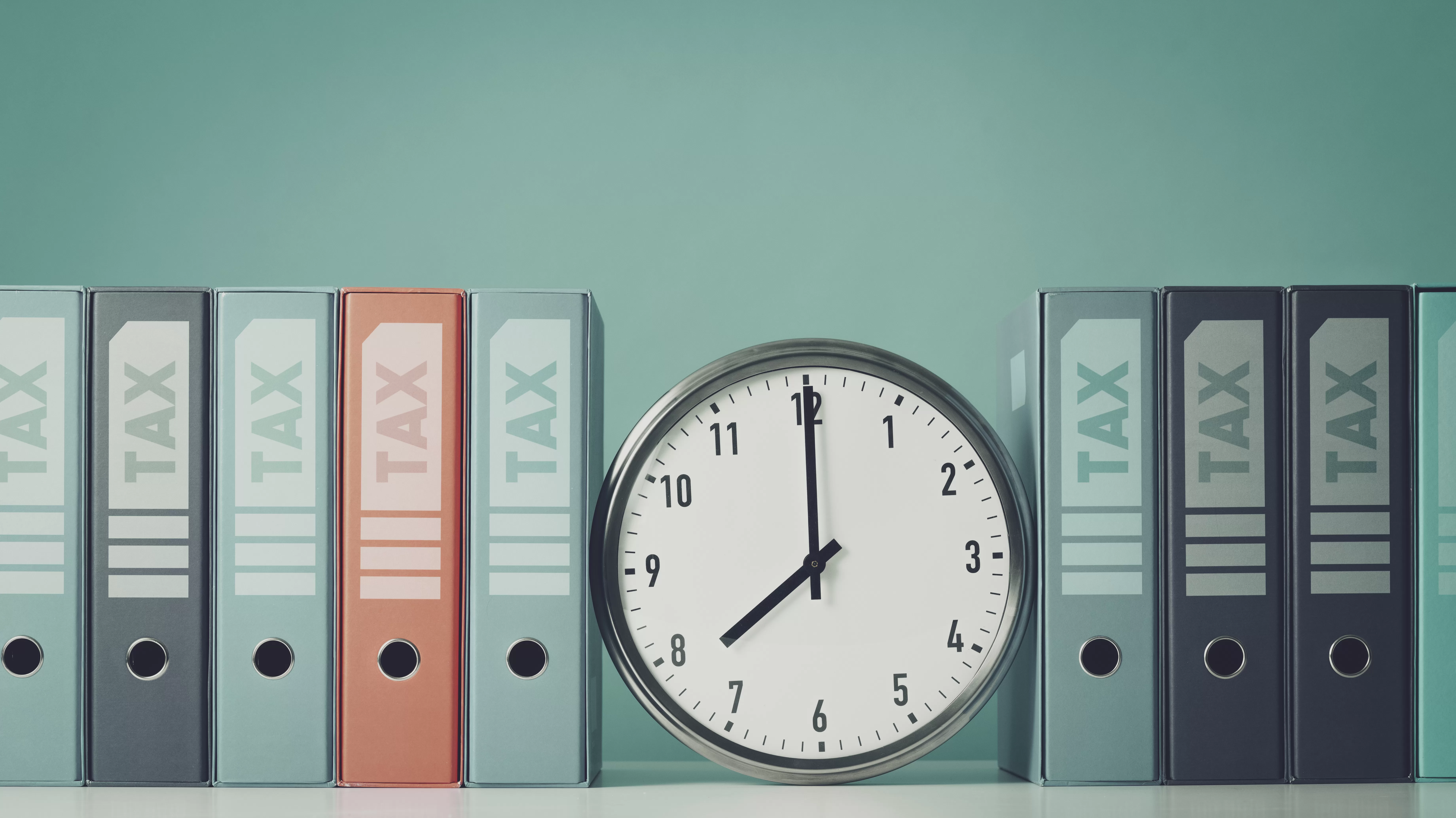 Ring binders containing tax documents and clock. Submitting supporting documents to SARS doesn't need to be a daunting task.