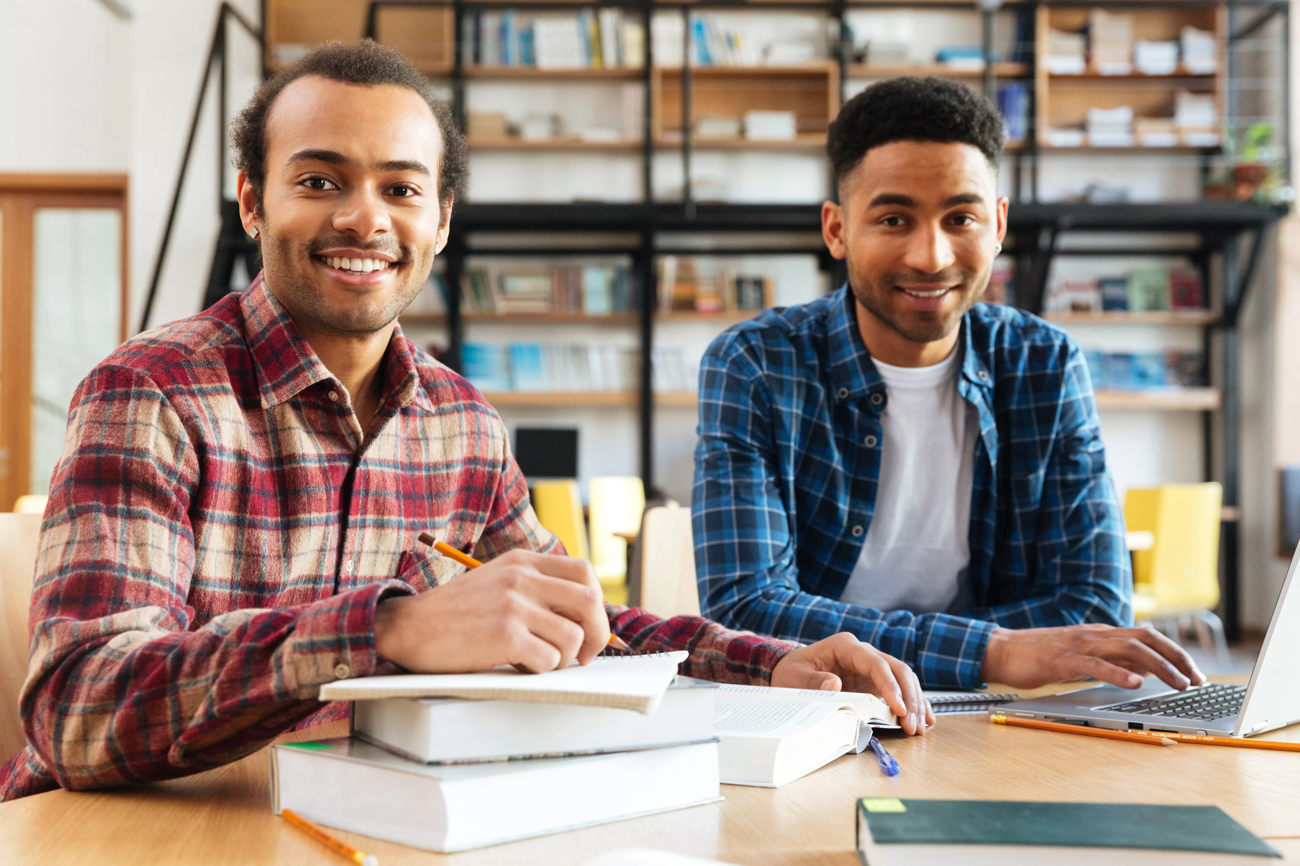 Young happy african men students sitting in library. The Power of Search: Searching for books from the NUST Library