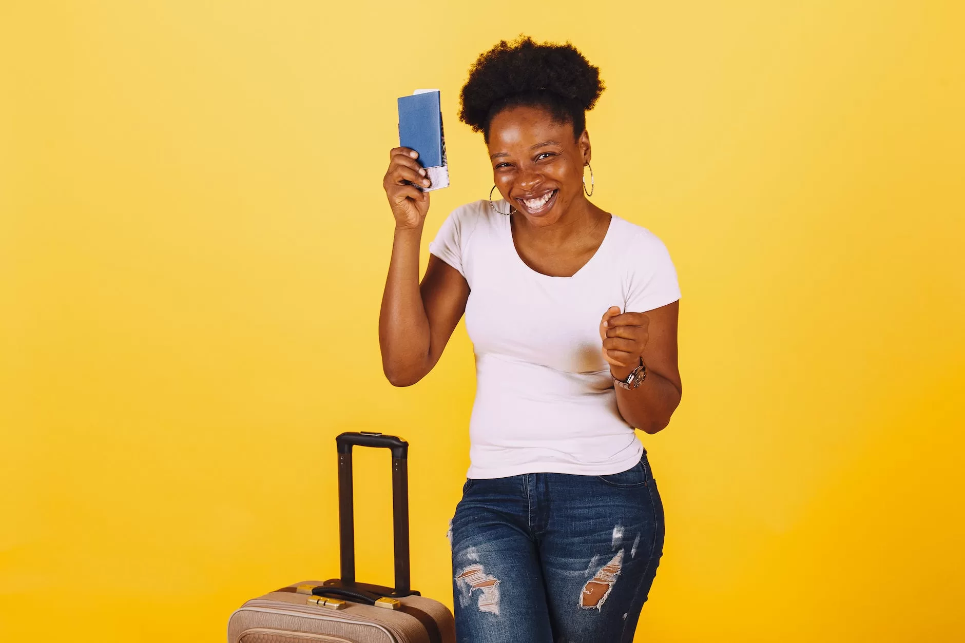 smiling woman in white shirt holding her passport