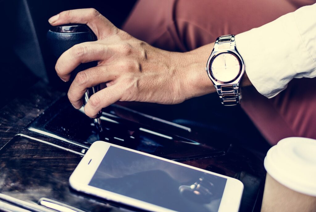 Woman holding a car gear | Downshifting: Mastering Gear Changing